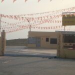 A view of the exterior during the daytime with decorations for festivities to be conducted.