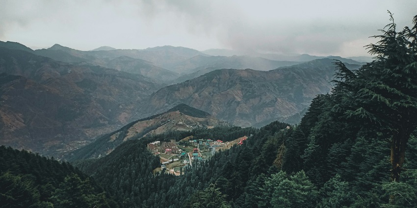 Green Fagu Valley with rolling hills and a clear blue sky - Himalayan Nature Park Kufri.