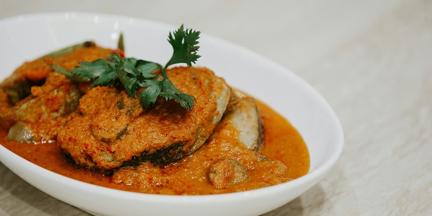 Image of fish curry served in a bowl - the Kerala style Fish Molee is one of the best food.