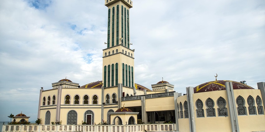 Elegant mosque built over water in Malacca, featuring golden domes, sea-facing prayer halls, and stunning reflections during sunset hours, one of the best mosques in Malaysia.