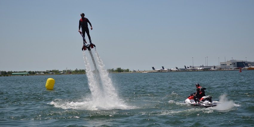 Snap of a man flying over the high pressure jet board in the ocean in the Flyboard India, Goa