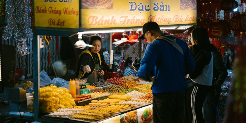 Go to Nguyen Hue Walking Street for shopping in Ho Chi Minh and explore street food, souvenirs, and fashion items.