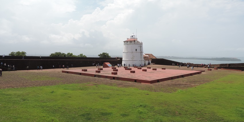 View of Aguada Fort’s aged stone walls and lighthouse overlooking the sea in Goa.