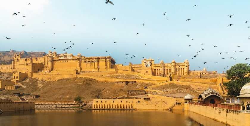 A breathtaking vista of a herd of birds flying over a tourist attraction in the region.