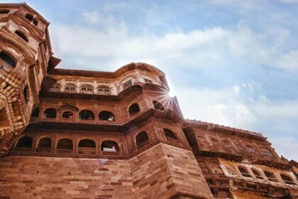 A low-angle view of the iconic tourist attraction of Rajasthan adorned with red shades.