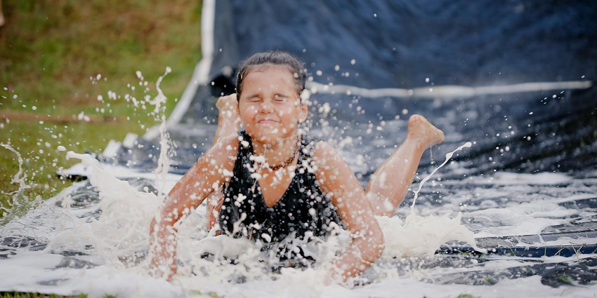 Girl on a thrilling ride on a slip like Fun World, one of the top Water parks in Bikaner