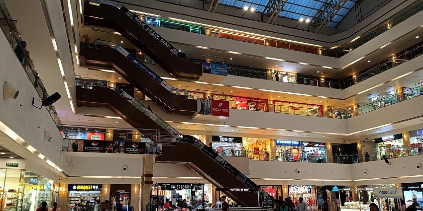 View of the luxurious corridors of the shopping plaza with tourists wandering around