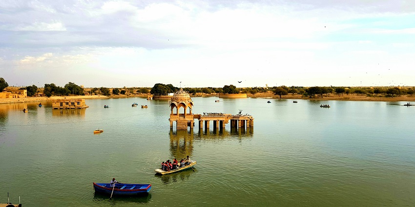 Scenic view of Gadisar Lake in Jaisalmer, with tranquil waters and ornate temples