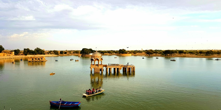 Colourful boats on Gadsisar Lake, offering a peaceful escape and birdwatching in Jaisalmer.