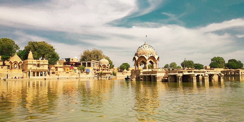 A scenic view of Gadisar Lake in Jaisalmer, a popular destination for tourists and locals.