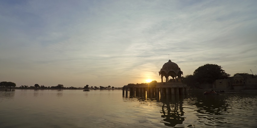 Sunset view of Gadsisar Lake in Jaisalmer with chhatri pavilion and calm reflective waters
