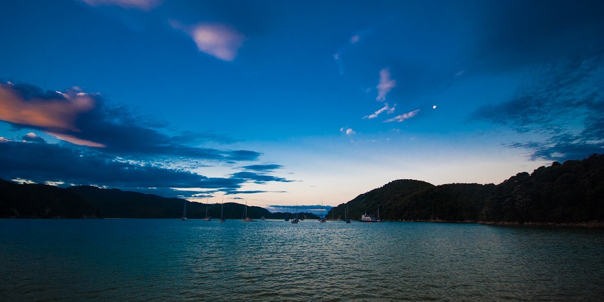 Gadsisar Sagar Lake at dusk features a tranquil, romantic, nature-filled evening