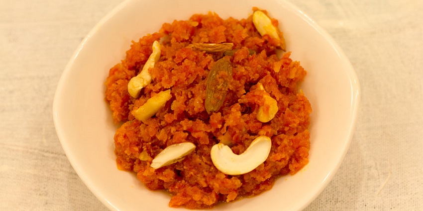 Sweet carrot pudding made with milk, sugar, and garnished with nuts and saffron.