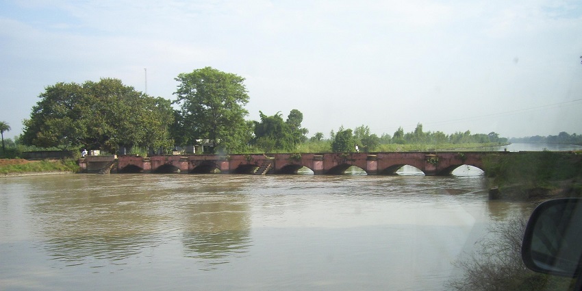 Scenic view of the Ganga canal, surrounded by lush greenery near the fort Rajwada in Ganganagar