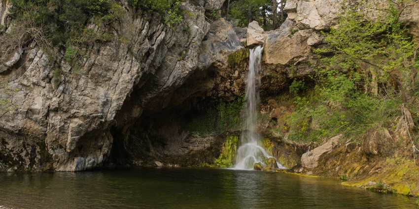 Image of a serene waterfall with lush greenery around, similar to the Garbhaji Water Fall