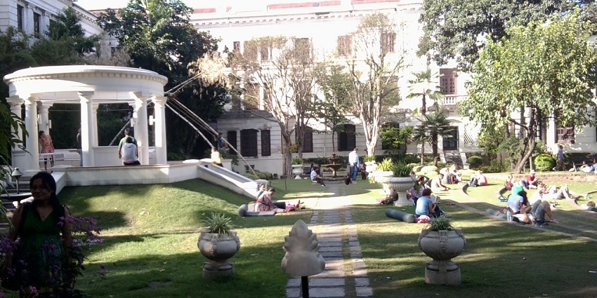 Serene Garden of Dreams with lush greenery and colonial-style architecture.