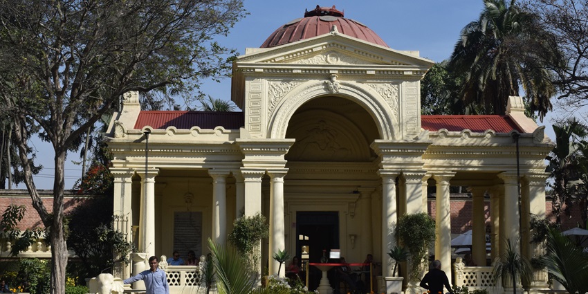 A serene garden oasis in Kathmandu, Nepal, featuring ornate pavilions and lush greenery.