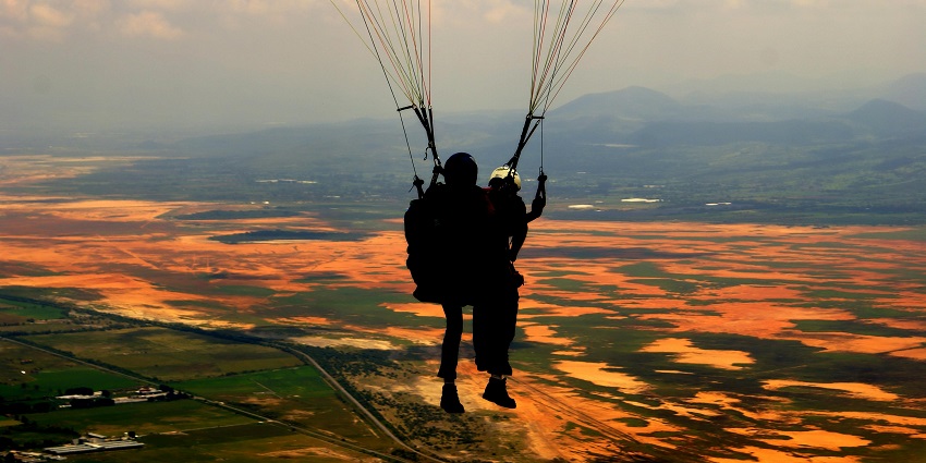 Two of the paragliders enjoying the beautiful and surreal view of water bodies below them