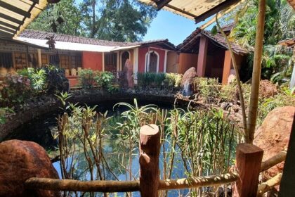 The interior view of the museum with a pond and trees around offering homely view.