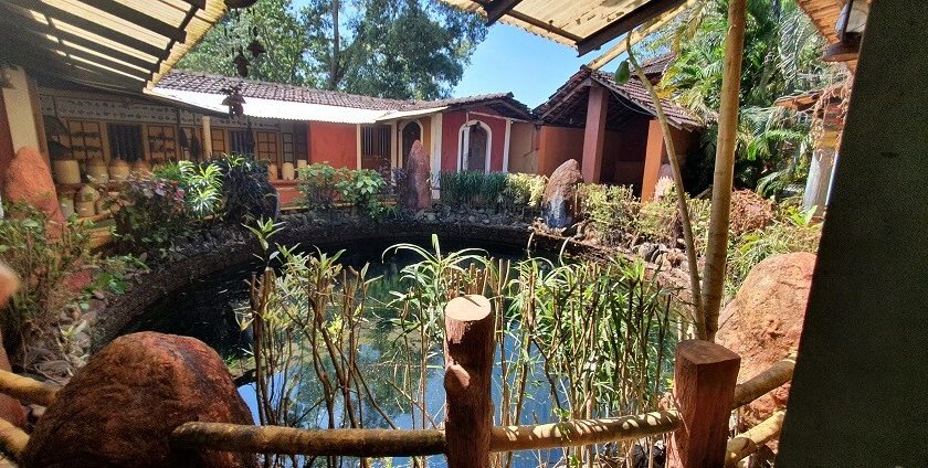 The interior view of the museum with a pond and trees around offering homely view.