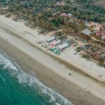 A bird’s eye view of shimmering waters meeting the pristine beaches of the region.