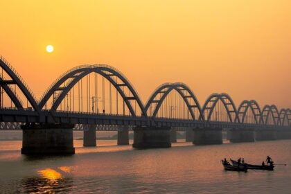 A stunning sunset casts vibrant colours over the Godavari Bridge - things to do in Rajahmundry.