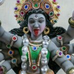 A detailed statue of Maa Kali with multiple arms, symbolising strength and divinity.