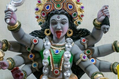 A detailed statue of Maa Kali with multiple arms, symbolising strength and divinity.