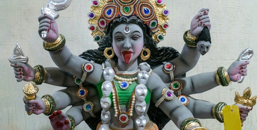 A detailed statue of Maa Kali with multiple arms, symbolising strength and divinity.