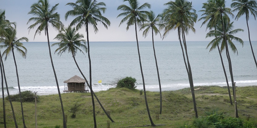 The famous beach in Gokarna, with smooth sands, traditional fishing boats, and calm waves.