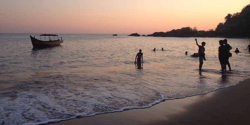 Gokarna Beach, with golden sands, a sunset view, and a boat gliding over the waters, is among the best beaches near Belgaum.