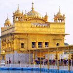 Punjab Golden Temple under clear blue sky, devotees standing in a line - explore hill stations near punjab