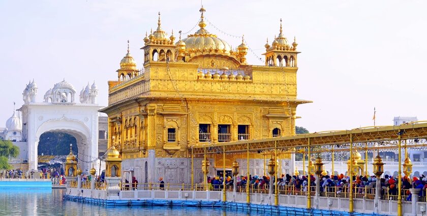 Punjab Golden Temple under clear blue sky, devotees standing in a line - explore hill stations near punjab