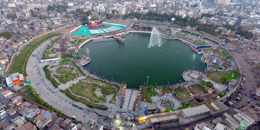 Bird's-eye view of Gopi Talav, a serene lake surrounded by lush greenery for a peaceful escape.