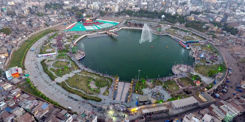 Aerial view of Gopi Talav in Surat with the lake and surrounded by tall buildings