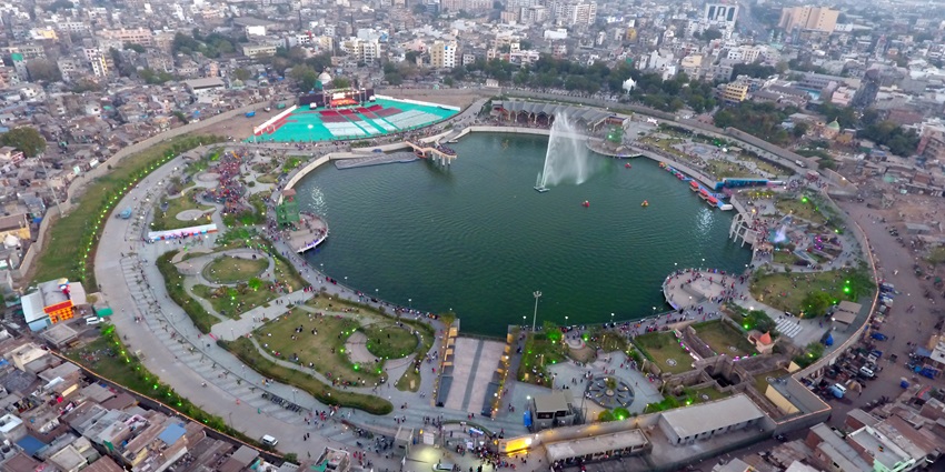 Gopi Talav in Surat featuring landscaped gardens, walking paths, and a large pond.
