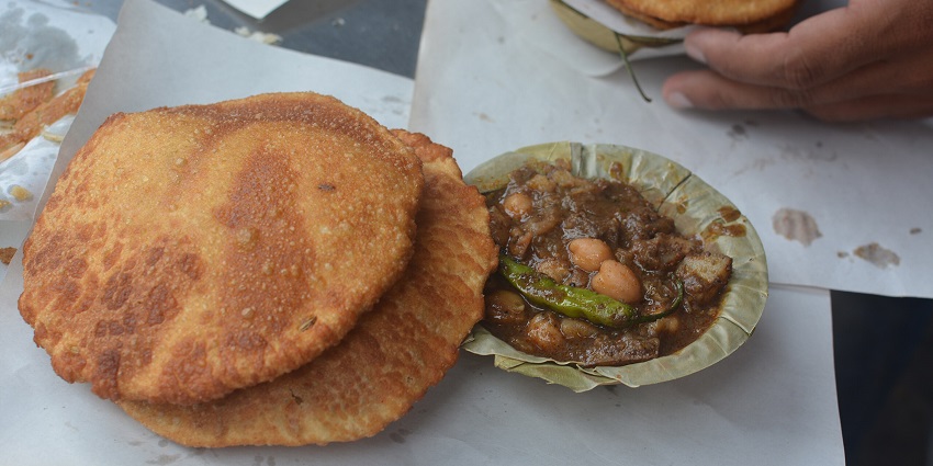 Plate of Kachori served with a side of flavorful sabji in a traditional Indian meal