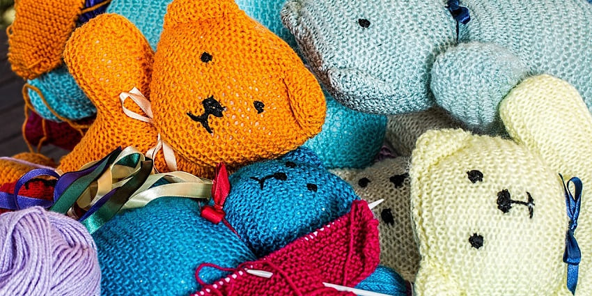 Hand-knitting in progress with vibrant yarn and needles, representing handmade crafts and shopping in Ahmedabad.