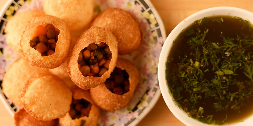 Snapshot of the Pani Puri being served in the Bowl with masala water on a plate