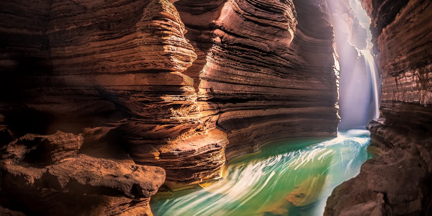 Close up view of the trails inside the cave with crystal clear water at the bottom