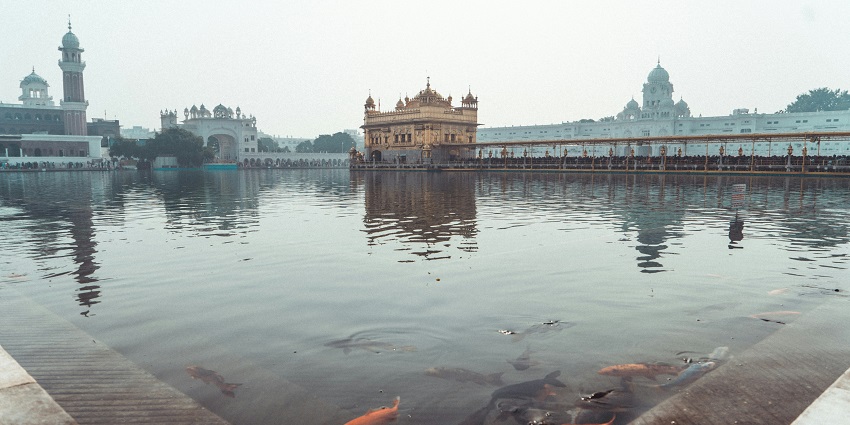 Peaceful and sacred Gurdwara Garna Sahib surrounded by calm waters and serene landscapes.