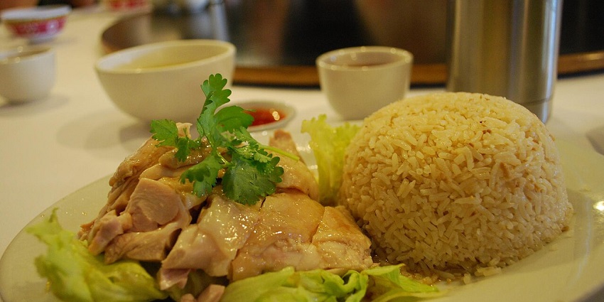 Hainanese chicken rice served with dipping sauces - one of the best foods in Singapore.