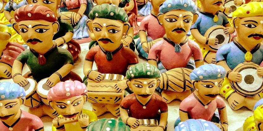 Colourful traditional folk costumes displayed on mannequins against a bright backdrop.