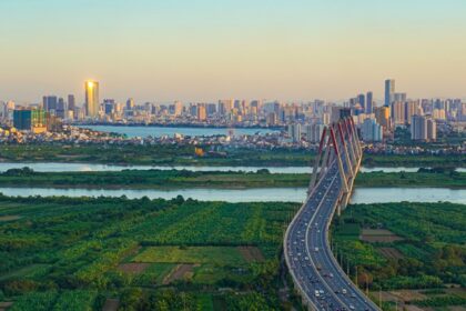 Dusk over Hanoi's skyline, with city lights aglow. A highlight among places to visit in Hanoi.