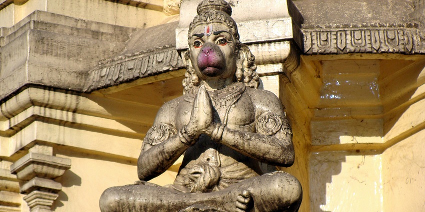 A close-up of a statue of Hanuman, showcasing intricate details and textures.
