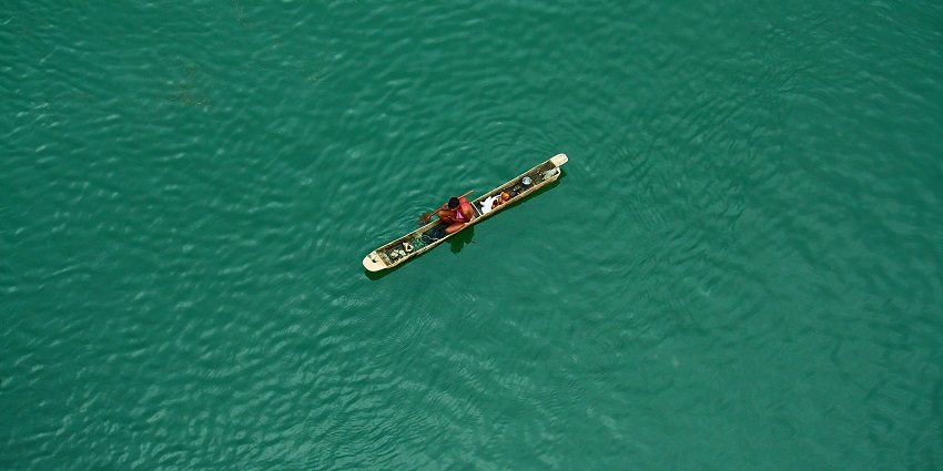 A scenic view of the Narmada River, with its wide, flowing waters meandering through the lush green landscape.