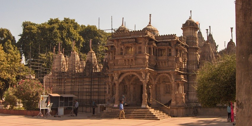 The Hathee Singh Jain temple in Ahmedabad featuring marble wall carvings and intricate architecture.