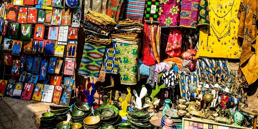 A view of colourful clothes, handicrafts, and plates being sold at Hauz Khas Village.
