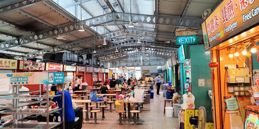 A picture of a Hawker Centre in Singapore with multiple fast food restaurants lined up