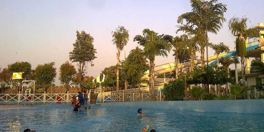 Beautiful view of the pool where people are having fun during the summer in Goa